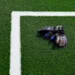 a soccer goalie's glove laying on a soccer field