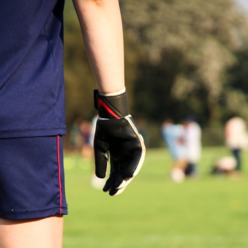 young goalkeeper with youth goalie gloves